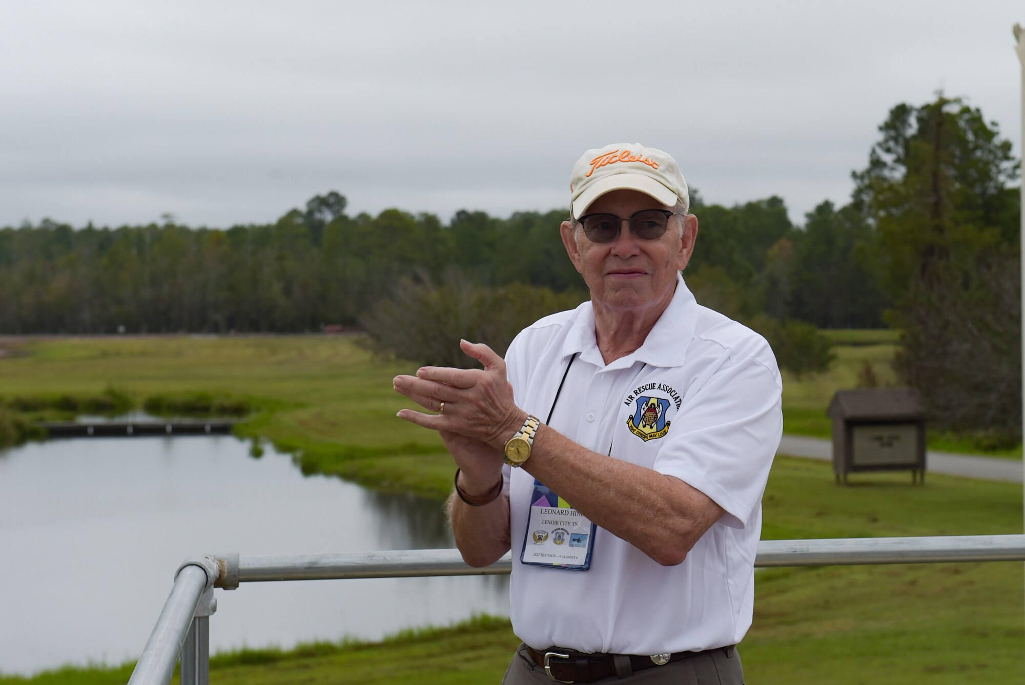 Leonard Hines, Air Rescue Association member, applauds a combat search and rescue demonstration over Grand Bay Bombing and Gunnery Range at Moody Air Force Base, Georgia, Sept. 9, 2022. Air Rescue Association members, who were once a part of the rescue community, watched the demonstration and attended a ceremony to celebrate the HH-60W Jolly Green II meeting the criteria for initial operational capability. (U.S. Air Force photo by Airman 1st Class Briana Beavers)