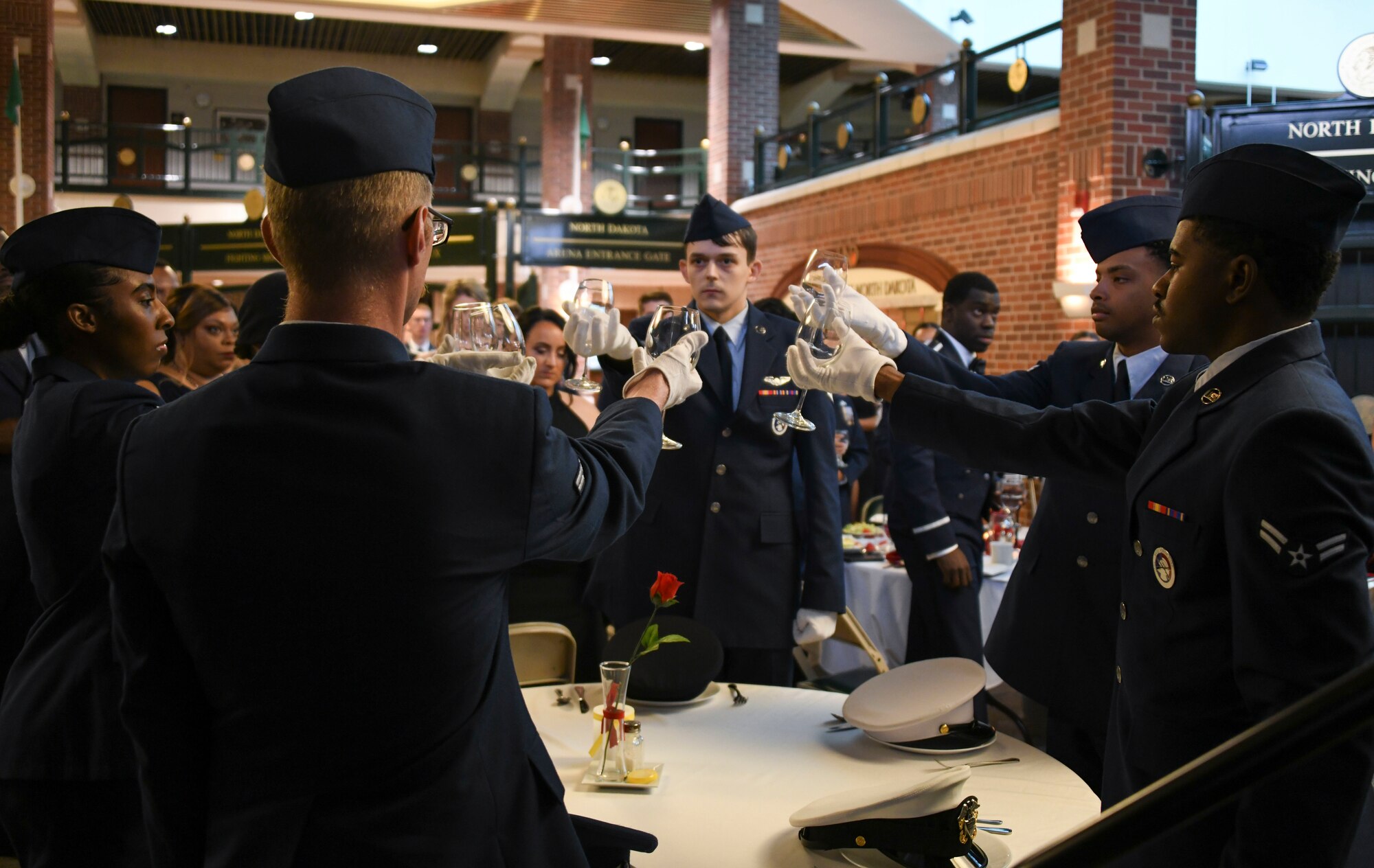 Grand Forks Air Force Base honor guardsmen preform a ceremony to honor American prisoners of war and service members missing in action during the 319th reconnaissance Wing’s celebration of the Air Force’s 75th birthday at the Ralph Englestad Arena in Grand Forks, North Dakota, Sept. 16, 2022. The theme for the ball called airmen to “Innovate, Accelerate and Thrive,” to celebrate what the Air Force was able to accomplish over the past 75 years of service and to look forward to a bright future. (U.S. Air Force photo by Senior Airman Roxanne A. Belovarac)