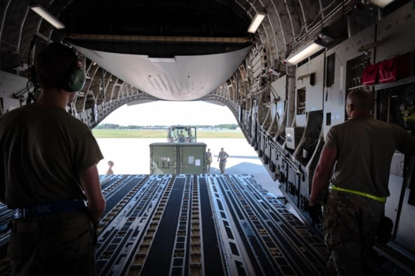 Airmen observe as cargo is loaded onto C-17 ramp