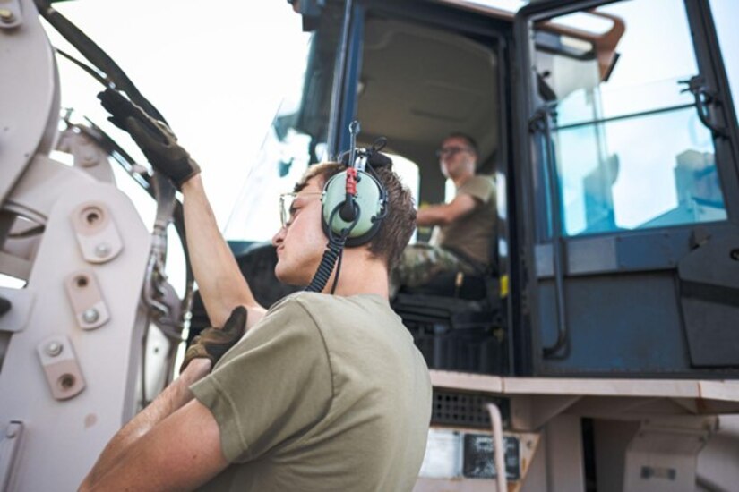 Man spots man operating forklift