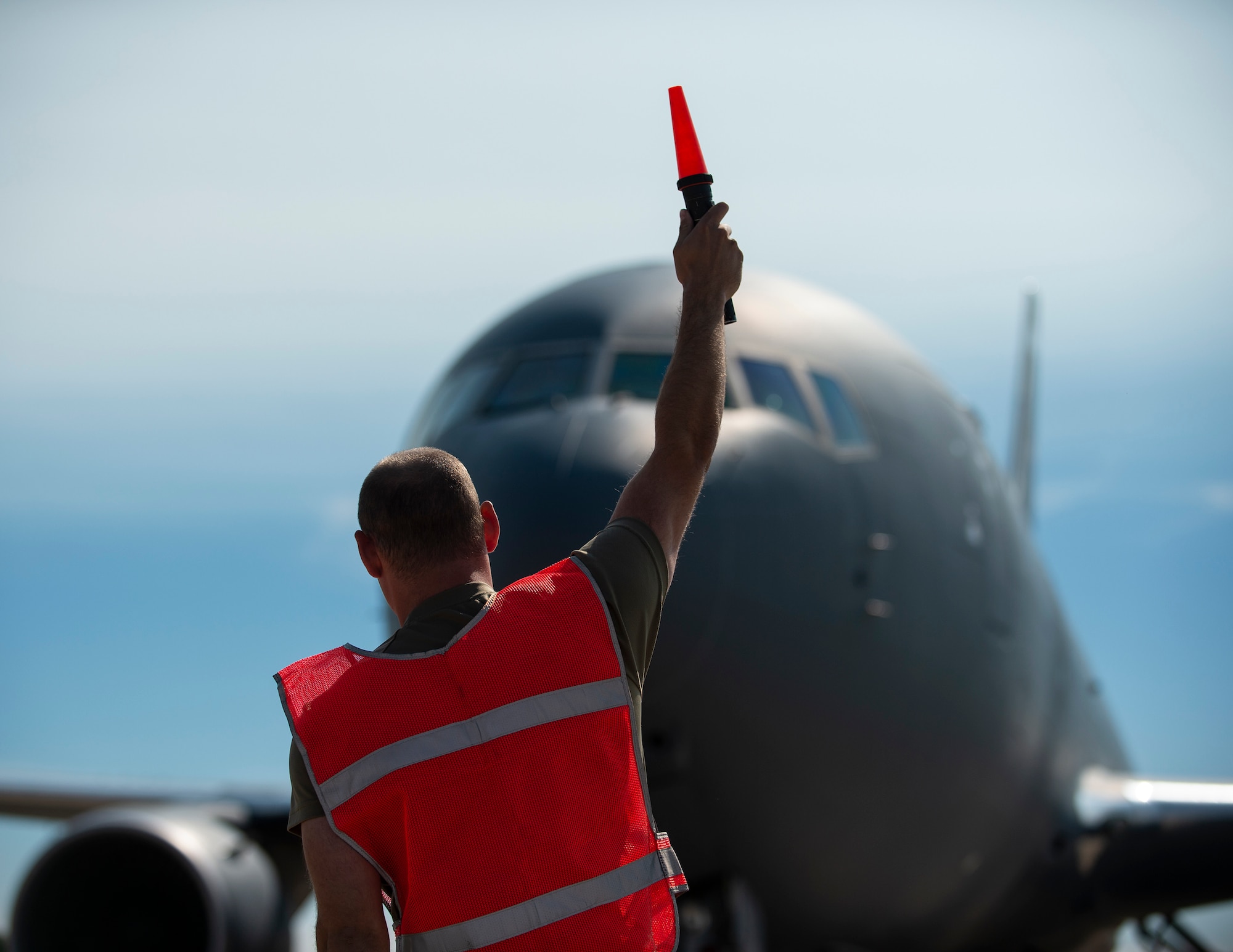 U.S. Air Force Senior Airman Scott Milbradt, 133rd Aircraft Maintenance Squadron, marshals a KC-46 Pegasus, 157th Air Refueling Wing, New Hampshire Air National Guard, to its parking spot in St. Paul, Minn., Sept. 12, 2022.