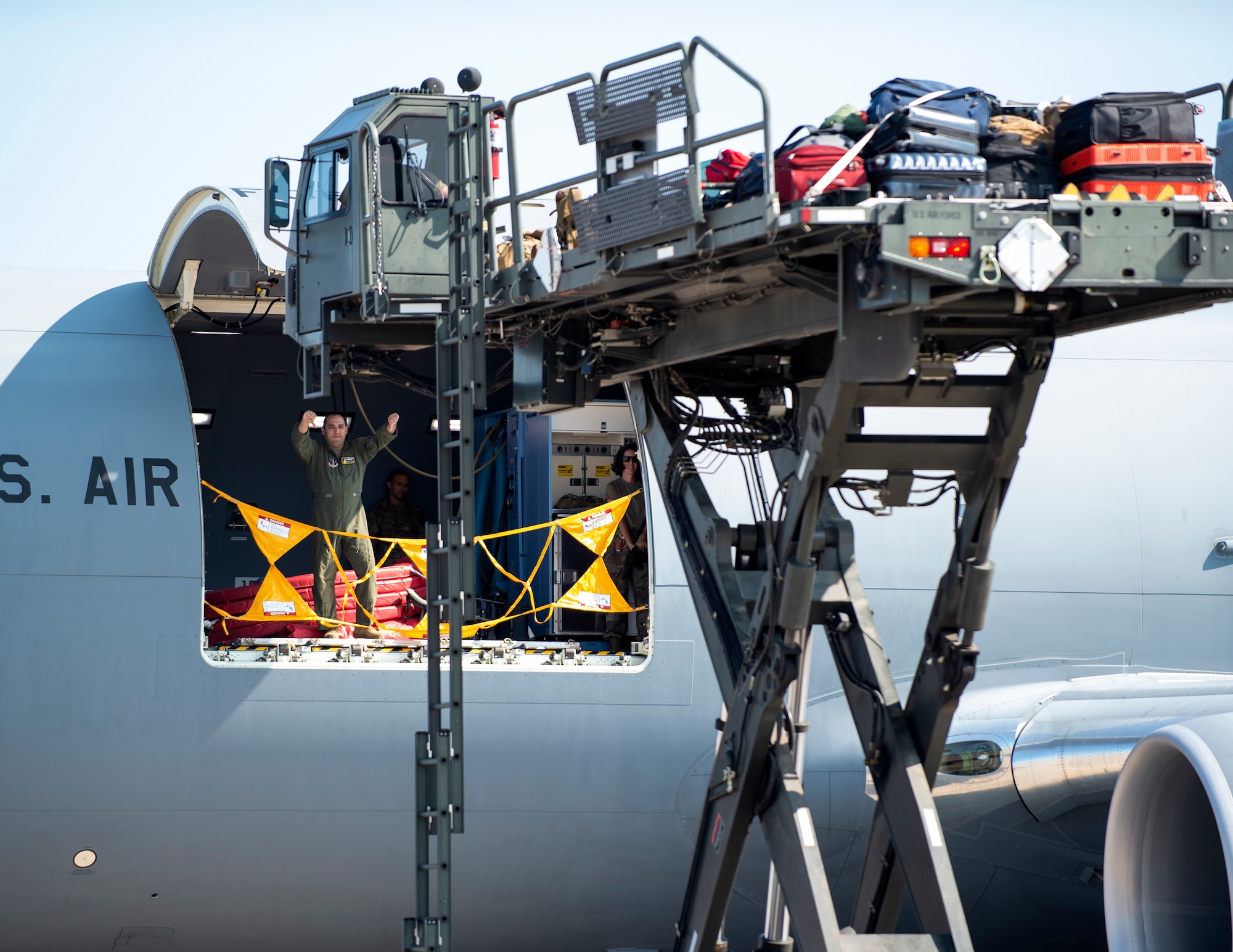A U.S. Air Force Airman from the 133rd Air Refueling Squadron, directs U.S. Air Force Tech. Sgt. Brian Forman, K-loader operator, 133rd Air Transportation Function, into passion in St. Paul., Minn., Sept. 12, 2022.