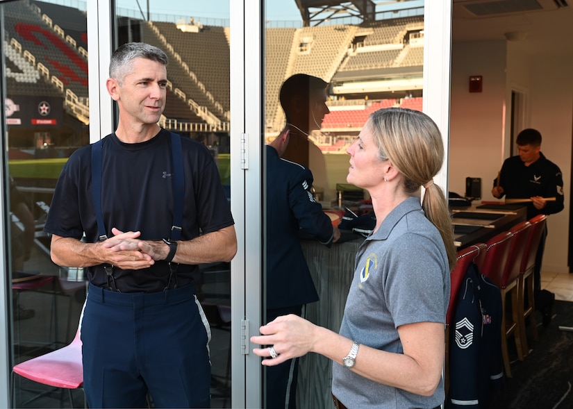 U.S. Air Force Senior Master Sgt. Randy Gorman, percussionist in and superintendent of the United States Air Force Band Concert Band, speaks with U.S. Air Force Col. Cat Logan, commander, Joint Base Anacostia-Bolling and the 11th Wing, Washington, D.C. on Sept. 15, 2022 before the 75th Air Force Anniversary Tattoo event at Audi Field. The Band and the United States Air Force Honor Guard serve as the branch's premier ceremonial units, whose mission is to represent Airmen to the world and inspire future recruits. (U.S. Air Force photo by Tech. Sgt. Kayla White)