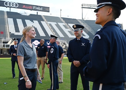 U.S. Air Force Col. Cat Logan, commander, Joint Base Anacostia-Bolling and the 11th Wing, Washington, D.C. engages with members of the United States Air Force Honor Guard on Sept. 15, 2022 before the 75th Air Force Anniversary Tattoo event at Audi Field. The Honor Guard and the United States Air Force Band serve as the branch's premier ceremonial units, whose mission is to represent Airmen to the world and inspire future recruits. (U.S. Air Force photo by Tech. Sgt. Kayla White)