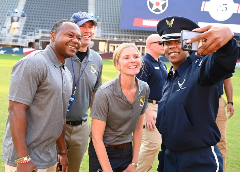 U.S. Air Force Col. Cat Logan and Chief Master Sgt. Clifford Lawton, commander and command chief of Joint Base Anacostia-Bolling and the 11th Wing, Washington, D.C., pose for a selfie with members of the Unites States Air Force Honor Guard before the 75th Air Force Anniversary Tattoo event at Audi Field on Sept. 15, 2022. The Honor Guard and the United States Air Fore Band are the branch's premier ceremonial units, representing the Air Force to the world and inspiring future recruits. (U.S. Air Force photo by Tech. Sgt. Kayla White)