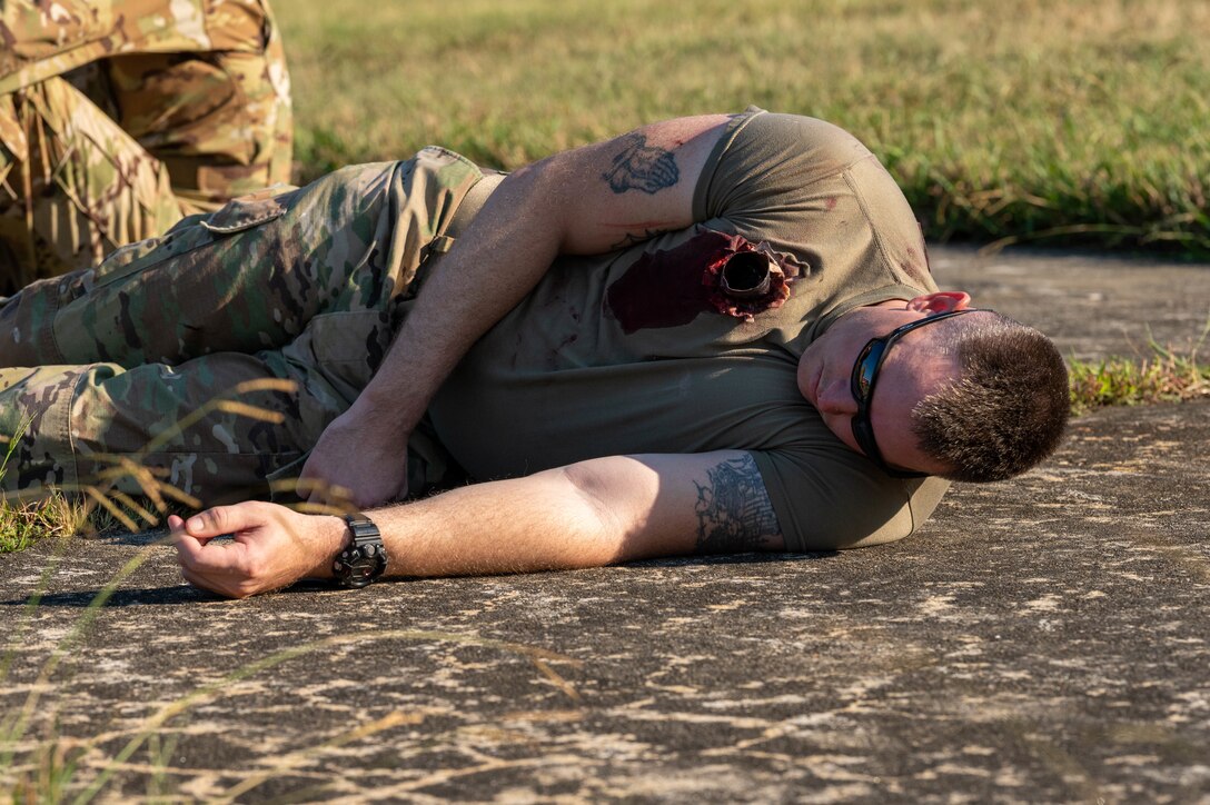 U.S. Army Specialist Joshua Smith, 567th Inland Cargo Transportation Company cargo specialist, plays the role of a critically injured victim in the aircraft down exercise at Joint Base Langley-Eustis, Virginia, Sept. 20, 2022.