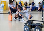 IMAGE: Fifth-grade students from Virginia Beach’s Linkhorn Park Elementary School ham it up for the camera attached to an explosive ordinance disposal robot. The robot was part of Naval Surface Warfare Center Dahlgren Division Dam Neck Activity’s STEM station at the Naval Air Station Oceana Air Show.
