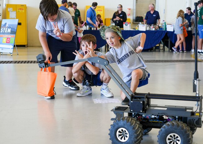 IMAGE: Fifth-grade students from Virginia Beach’s Linkhorn Park Elementary School ham it up for the camera attached to an explosive ordinance disposal robot. The robot was part of Naval Surface Warfare Center Dahlgren Division Dam Neck Activity’s STEM station at the Naval Air Station Oceana Air Show.