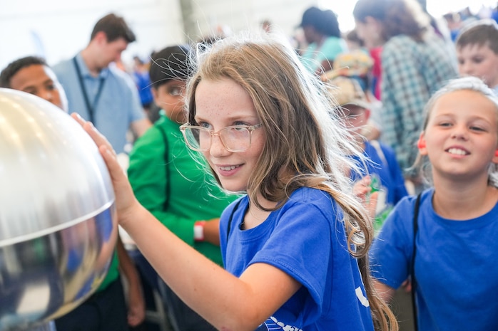 IMAGE: The Van de Graaff generator at the Naval Surface Warfare Center Dahlgren Division Dam Neck Activity (NSWCDD DNA) STEM station was one of the more popular stops for Virginia Beach area fifth-graders who were visiting the first day of the Naval Air Station Oceana Air Show. The generator was among the STEM-related activities presented to the students by scientists and engineers from NSWCDD DNA who volunteered their time.