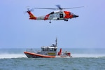 Coast Guard crews from Station Little Creek, Virginia and Air Station Elizabeth City, North Carolina conduct helicopter hoist training off the coast of Virginia Beach, July 26, 2021. Coast Guard members around the nation practice their craft daily to remain Semper Paratus, Always Ready. U.S. Coast Guard photo by Petty Officer 1st Class Stephen Lehmann.