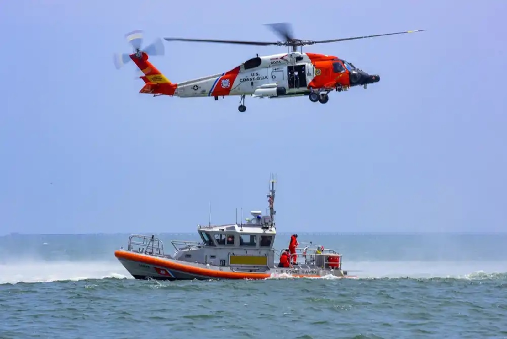 Coast Guard crews from Station Little Creek, Virginia and Air Station Elizabeth City, North Carolina conduct helicopter hoist training off the coast of Virginia Beach, July 26, 2021. Coast Guard members around the nation practice their craft daily to remain Semper Paratus, Always Ready. U.S. Coast Guard photo by Petty Officer 1st Class Stephen Lehmann.