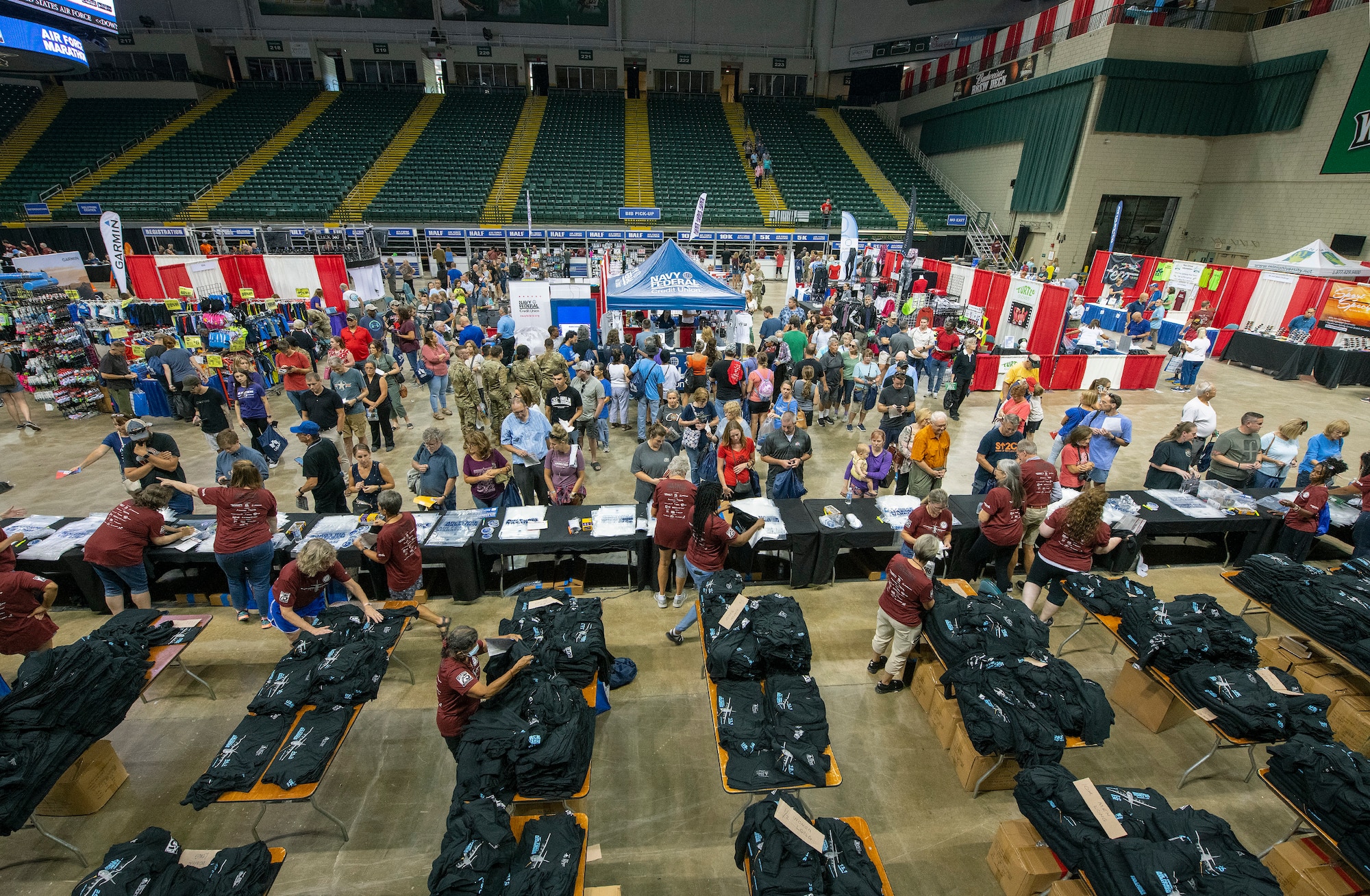 Air Force Marathon participants collect their race bibs and T-shirts during the Health & Fitness Expo on Sept. 15, 2022, at Wright State University’s Nutter Center, Fairborn, Ohio. The Expo featured about 75 exhibitors specializing in the latest developments in health, fitness and nutrition. Yoga and a mobility clinic were also offered. (U.S. Air Force photo by R.J. Oriez)