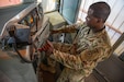U.S. Army Reserve Sgt. 1st Class Jonathan L. Sims, a senior rail advisor of the 757th Expeditionary Railway Center (ERC), demonstrates air brake controls in a locomotive at Joint Base Langley-Eustis, Virginia, August 6, 2022. Sims, a Florida native, began his railway career as a railway equipment repairman and is now a locomotive engineer. (U.S. Army Reserve photo by Sgt. Therese Prats)