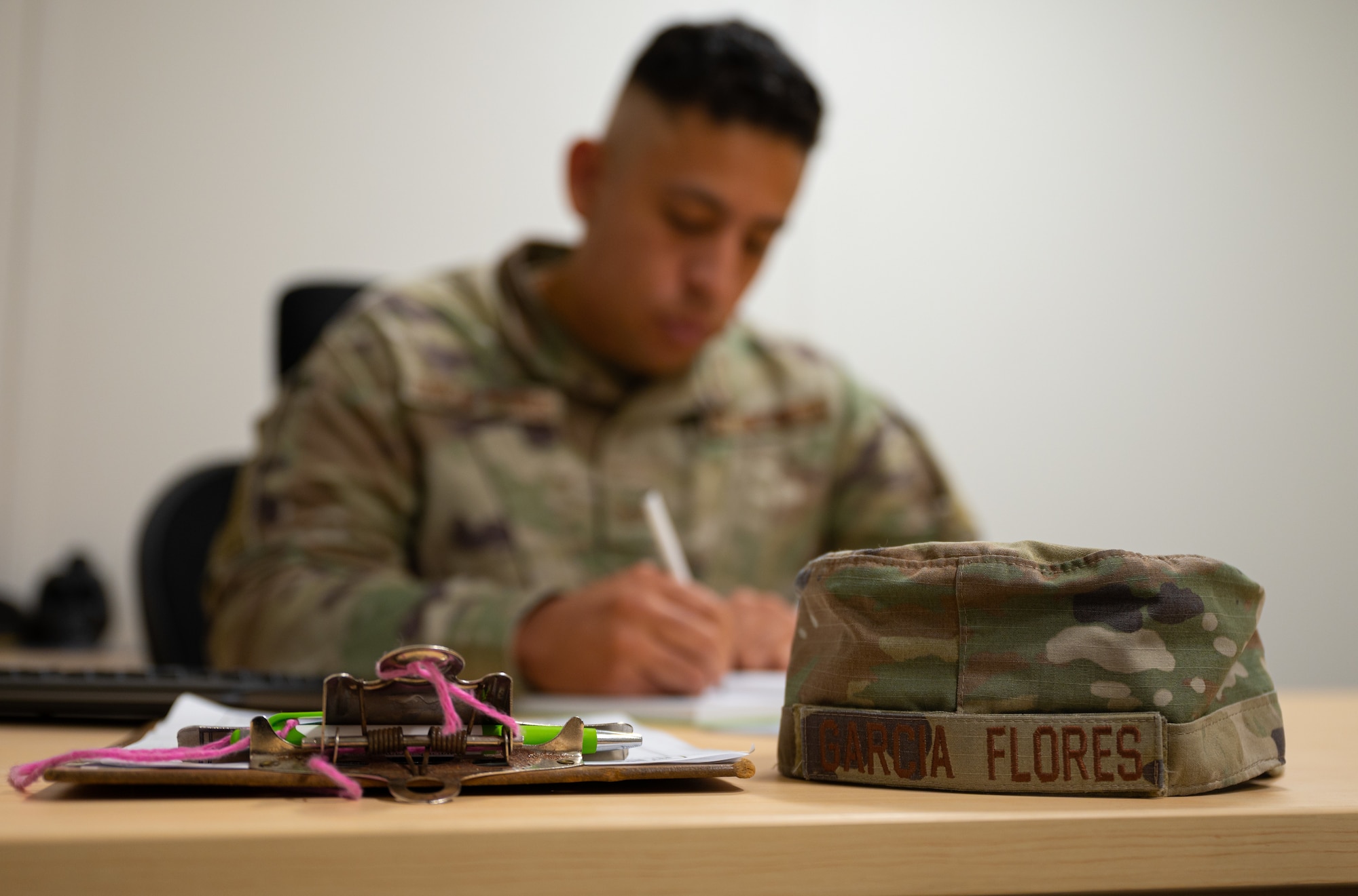 An airman sits at his desk