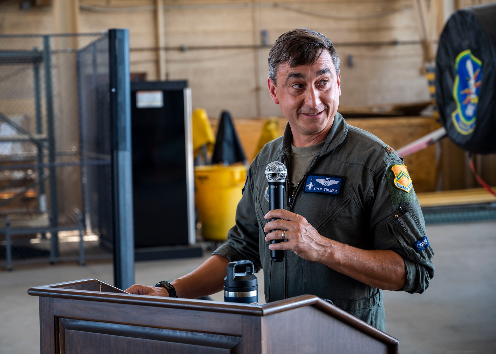 U.S. Air Force Maj. Lance “Trap” Tucker, 309th Fighter Squadron “Ducks” commander, speaks at the Block 25 Divestment aircraft signing Sept. 6, 2022, at Luke Air Force Base, Arizona.