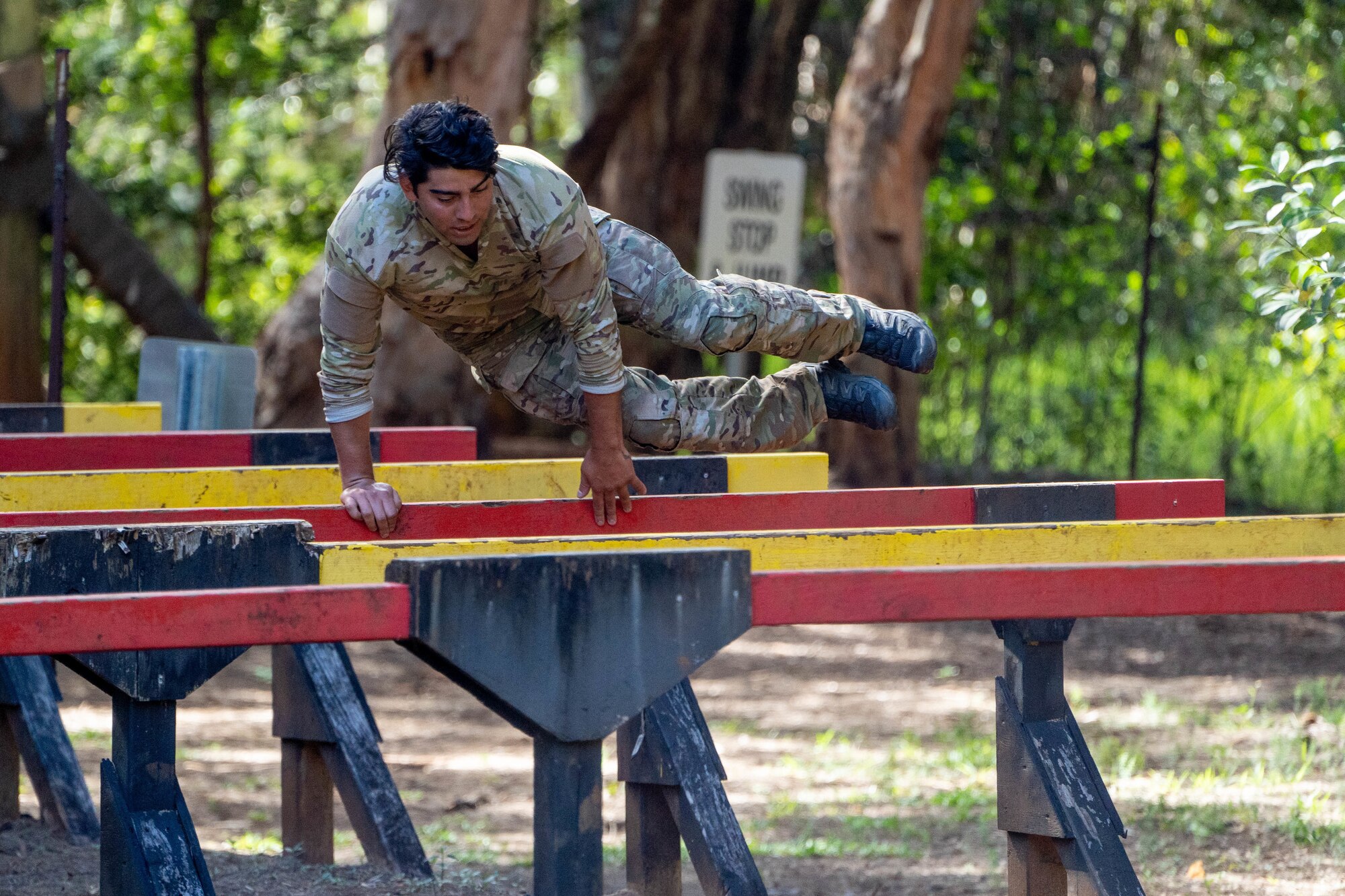 U.S. Air Force Staff Sgt. Jordan Falcon, 3rd Air Support Operations Squadron Detachment 1 tactical air control party specialist, completes an obstacle course during Chaos Challenge 2022 at Lightning Academy, Hawaii, Aug. 13, 2022. The event was a multi-day series of mental and physical challenges hosted by the 25th Air Support Operations Squadron. (U.S. Air Force photo by Senior Airman Makensie Cooper)
