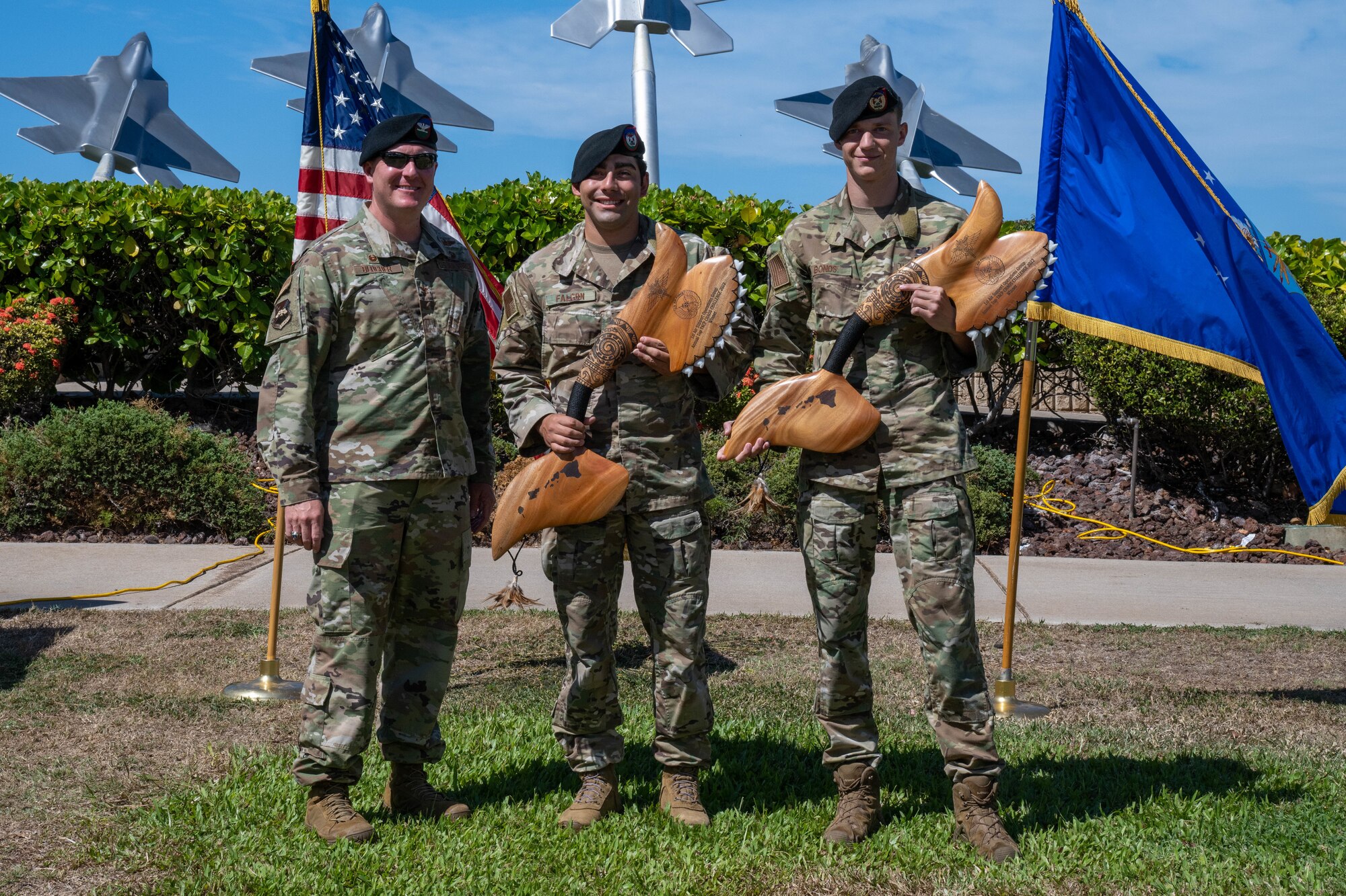 U.S. Air Force Col. John Blocher, 1st Air Support Operations Group commander, congratulates Staff Sgt. Jordan Falcon and Senior Airman Brenden Bonds, 3rd Air Support Operations Squadron Detachment 1 tactical air control party specialists, on winning first place in Chaos Challenge 2022 at Joint Base Pearl Harbor-Hickam, Aug. 16, 2022. The event is an annual competition highlighting Pacific Air Forces top two-person TACP team while completing mentally and physically challenging events revolving around field skills, land navigation, close air support skills and a wide spectrum of job knowledge task evaluations. (U.S. Air Force photo by Senior Airman Makensie Cooper)