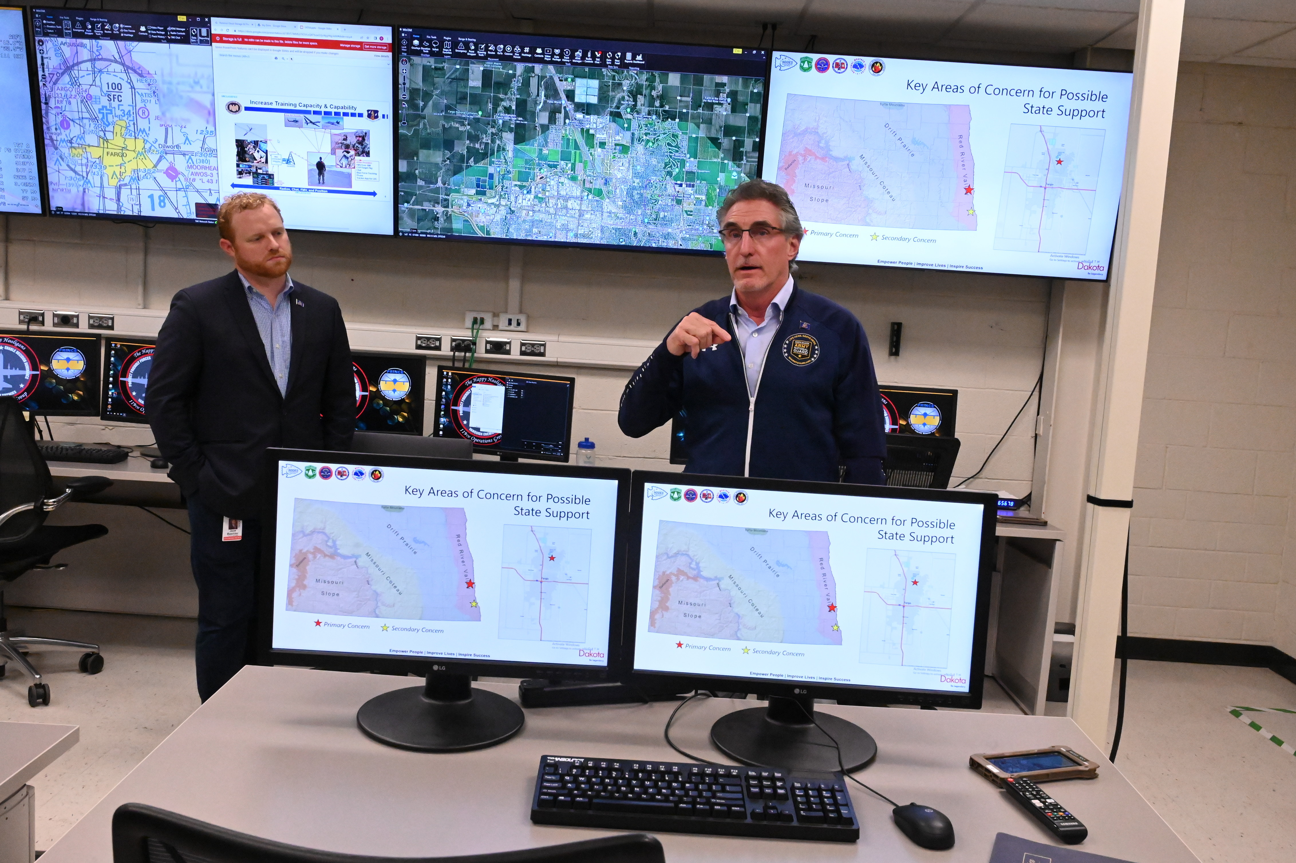 North Dakota Gov. Doug Burgum, right, discuses unit capabilities with 119th Operations Group members as Jace Beehler, the Office of the Governor chief of staff, looks on during an update and familiarity tour for the Governor at the North Dakota Air National Guard Base, Fargo, North Dakota, Sept. 14, 2022. (U.S. Air National Guard photo by David H. Lipp)