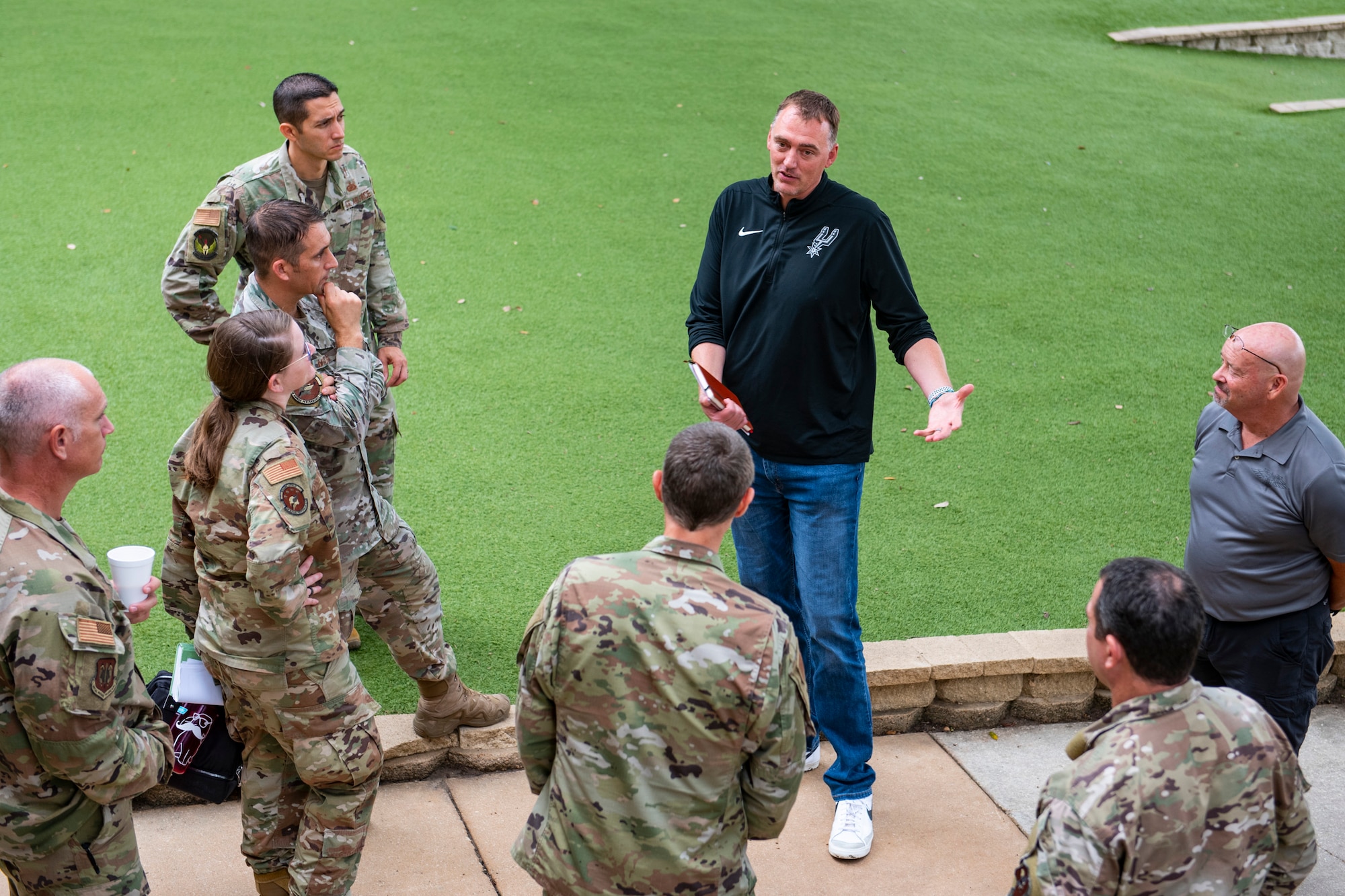 Phil Cullen, San Antonio Spurs director of basketball strategy, talks with members of the Special Warfare Training Wing during a quick tour of some of SWTW facilities at Joint Base San Antonio-Lackland, Texas, Aug. 15, 2022. The SWTW and Spurs met to discuss ideas and talk strategy on human performance. (U.S. Air Force photo by Brian J. Valencia)