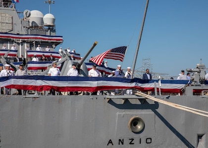 NORFOLK, Va. (Sept. 22, 2022) Sailors and plankowners of the Ticonderoga-class, guided-missile cruiser USS Anzio (CG 68) haul down the pennants, the jack, and the ensign during the ship’s decommissioning ceremony onboard Naval Station Norfolk, Sept. 22, 2022. Anzio was decommissioned after 30 years of service.  (U.S. Navy photo by Mass Communication Specialist 3rd Class Bradley Rickard
