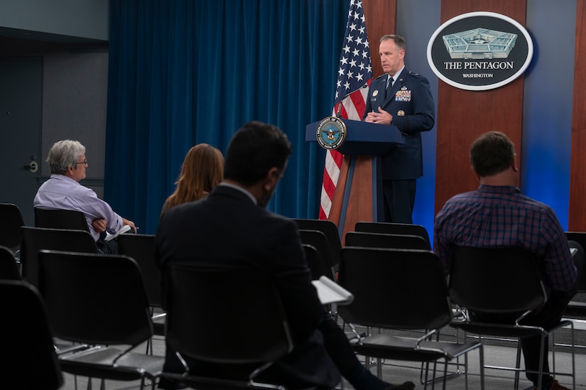 A man in a military uniform is standing at a lectern. The sign behind him indicates he is at the Pentagon.