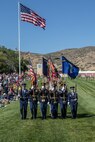 A color guard marches in a pass in review.