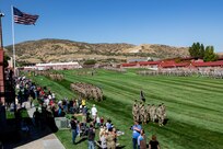 A large column of soldiers and airmen march in a  pass in review at Camp Williams, Utah.
