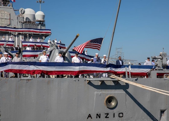 NORFOLK, Va. (Sept. 22, 2022) Sailors and plankowners of the Ticonderoga-class, guided-missile cruiser USS Anzio (CG 68) haul down the pennants, the jack, and the ensign during the ship’s decommissioning ceremony onboard Naval Station Norfolk, Sept. 22, 2022. Anzio was decommissioned after 30 years of service.  (U.S. Navy photo by Mass Communication Specialist 3rd Class Bradley Rickard