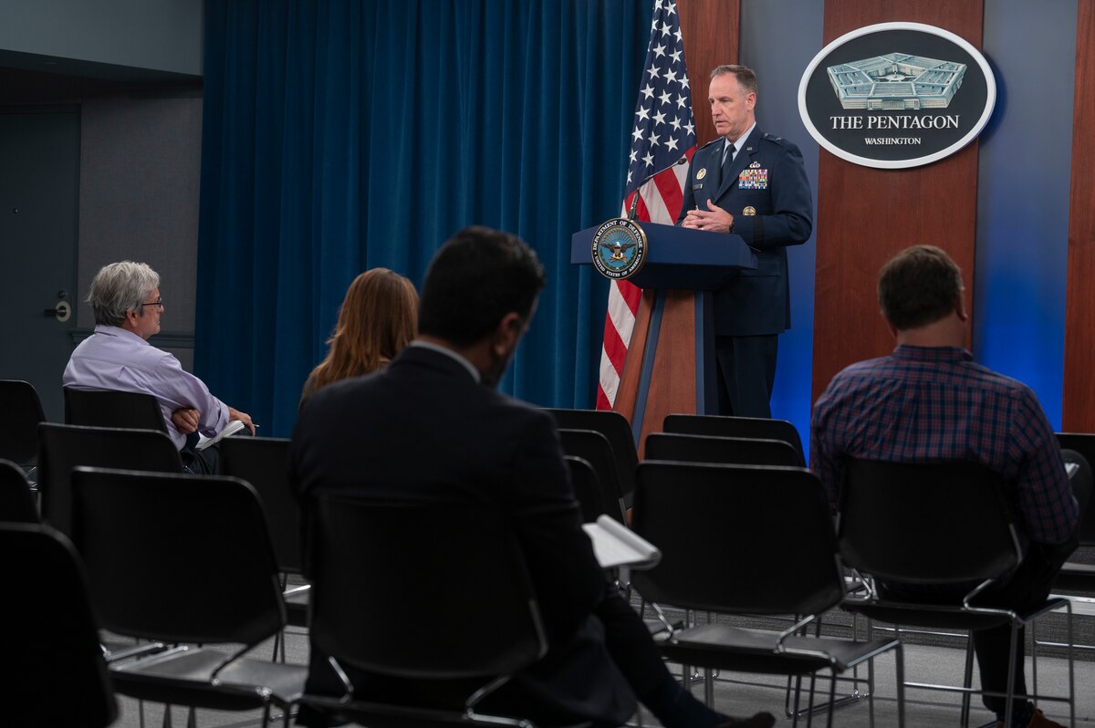A man in a military uniform is standing at a lectern. The sign behind him indicates he is at the Pentagon.