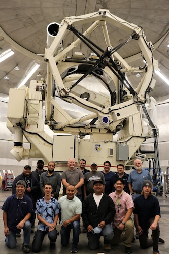 The 3.6-meter, 75-ton Advanced Electro-Optical System, or AEOS. telescope, shown with the mirror recoat team, is the largest optical telescope in the Department of Defense. The mirror received its second recoat since the installation of AEOS at the Air Force Maui Optical and Supercomputing site in 1997. AMOS is part of the Air Force Research Laboratory, and keeping the mirror in prime condition is key to the U.S. Space Force’s space domain awareness mission. (Courtesy photo / Boeing)