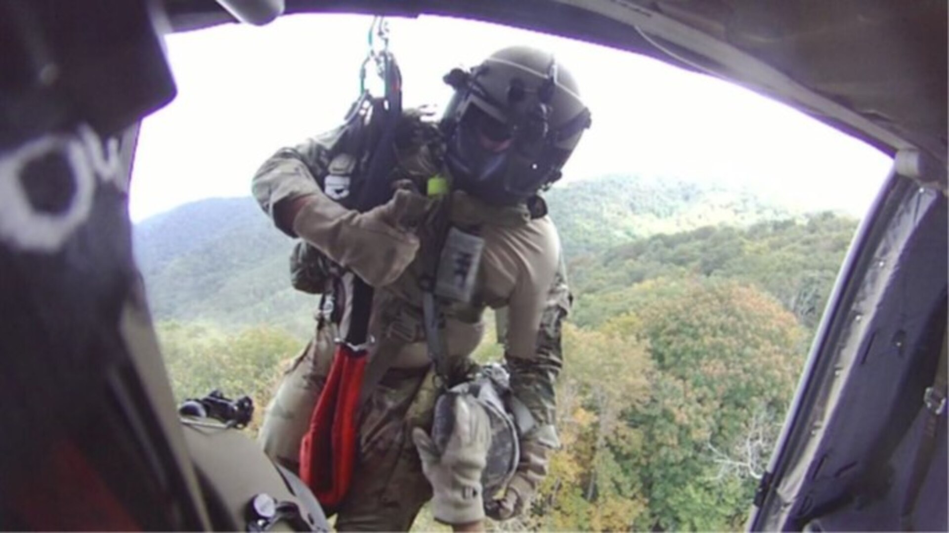 Sgt. 1st Class Giovanni DeZuani, a flight paramedic, is lowered from a UH-60 Black Hawk near Derrick Knob Shelter to rescue a hiker in distress along the Appalachian Trail Sept. 20, 2022. The flight crew from the Tennessee National Guard conducted the emergency air evacuation mission after a hiker reported chest pains.