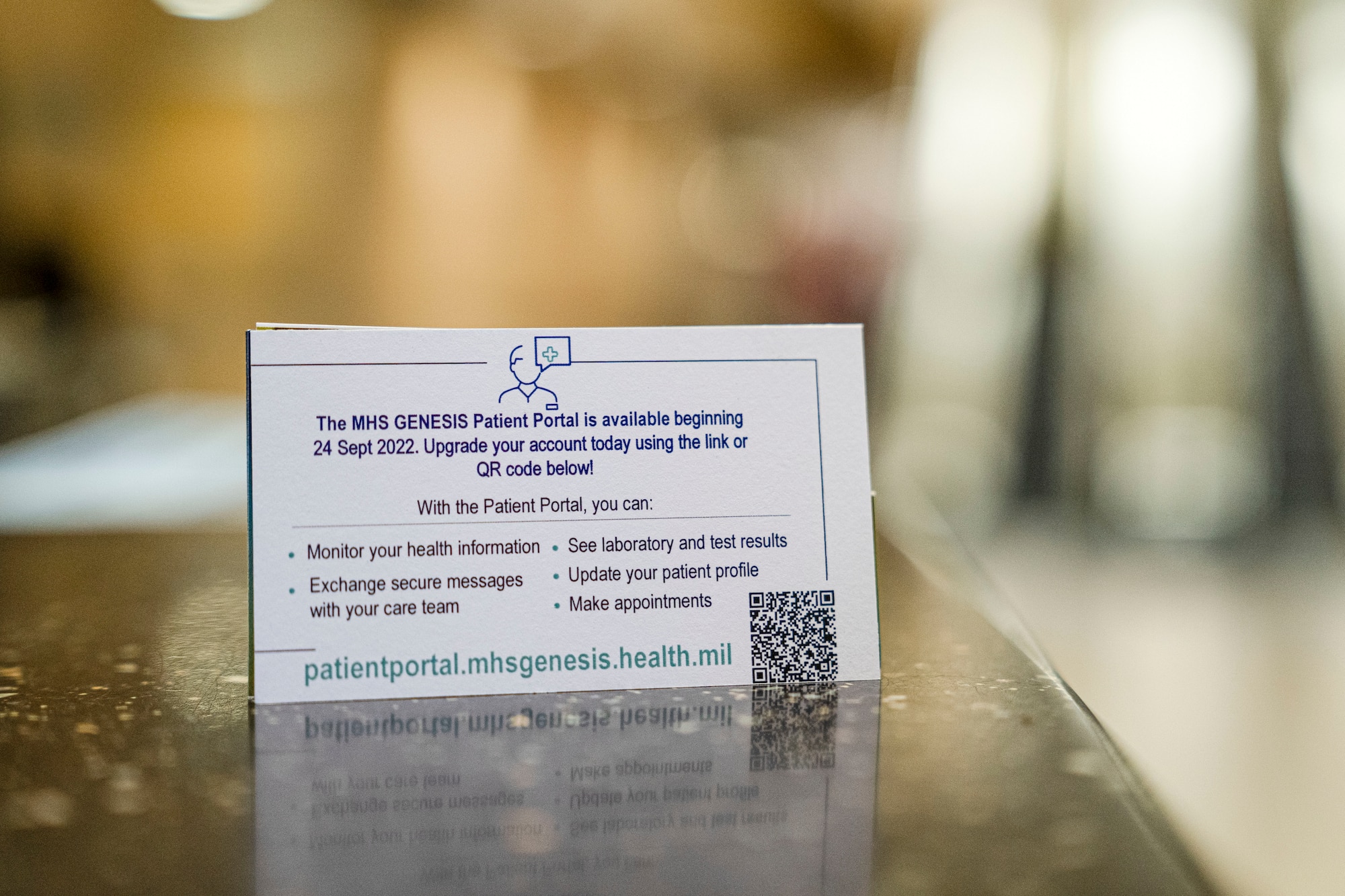 The card reads: The MHS GENESIS Patient Portal is available beginning 24 September 2022. Upgrade your account today using the QR Code below. With the patient portal you can monitor your health information, exchange secure messages with your care team, see laboratory test results, update your patient profile, make appointments. patientportal.mhsgenesis.health.mil