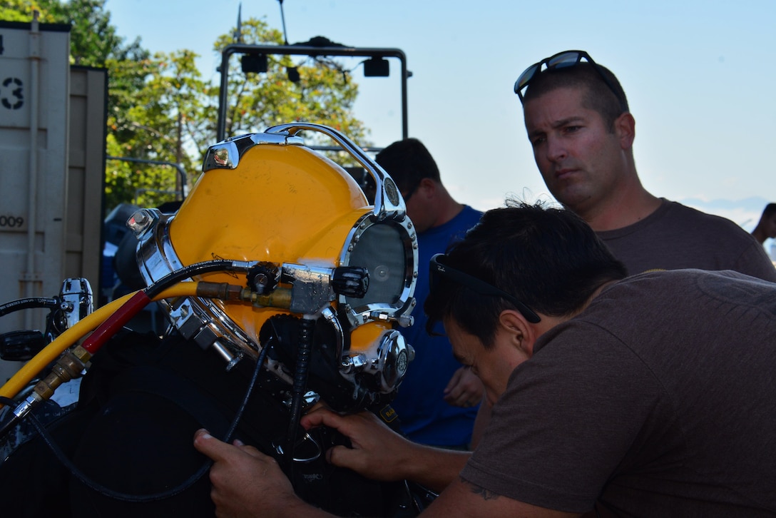 RIO DE JANEIRO – Members of Mobile Diving and Salvage Unit 2 (MDSU-2) checks a sailor’s gear before his dive during UNITAS LXIII, Sept. 19, 2022. UNITAS is the world’s longest-running maritime exercise. Hosted this year by Brazil, it brings together multinational forces from Brazil, Cameroon, Chile, Colombia, Dominican Republic, Ecuador, France, Guyana, Jamaica, Mexico, Namibia, Panama, Paraguay, Peru, South Korea, Spain, United Kingdom, Uruguay, and the United States conducting operations in and off the coast of Rio de Janeiro. The exercise trains forces to conduct joint maritime operations through the execution of anti-surface, anti-submarine, anti-air, amphibious and electronic warfare operations that enhance warfighting proficiency and increase interoperability among participating naval and marine forces. (U.S. Navy photo by Mass Communication Specialist 3rd Class Jahlena Royer/Released)