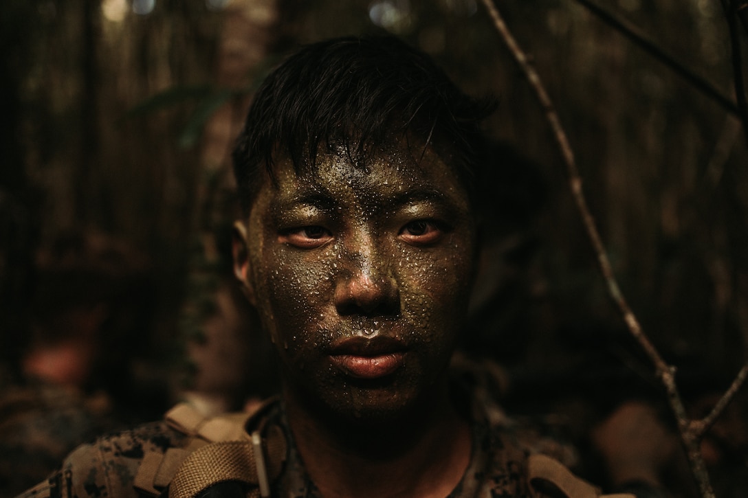 U.S. Marine Corps Lance Cpl. William Augsburger, a rifleman with Ground Sensor Platoon, 3rd Intelligence Battalion, III Marine Expeditionary Force Information Group, poses for a portrait during a field exercise at Jungle Warfare Training Center, Camp Gonsalvez, Okinawa, Japan, Sept. 13, 2022. GSP is a scalable specialized unit whose mission is to collect enemy signatures in order to provide Marine Air Ground Task Force commanders’ advanced warning of offensive attacks, counter enemy reconnaissance, and aid in force protection.