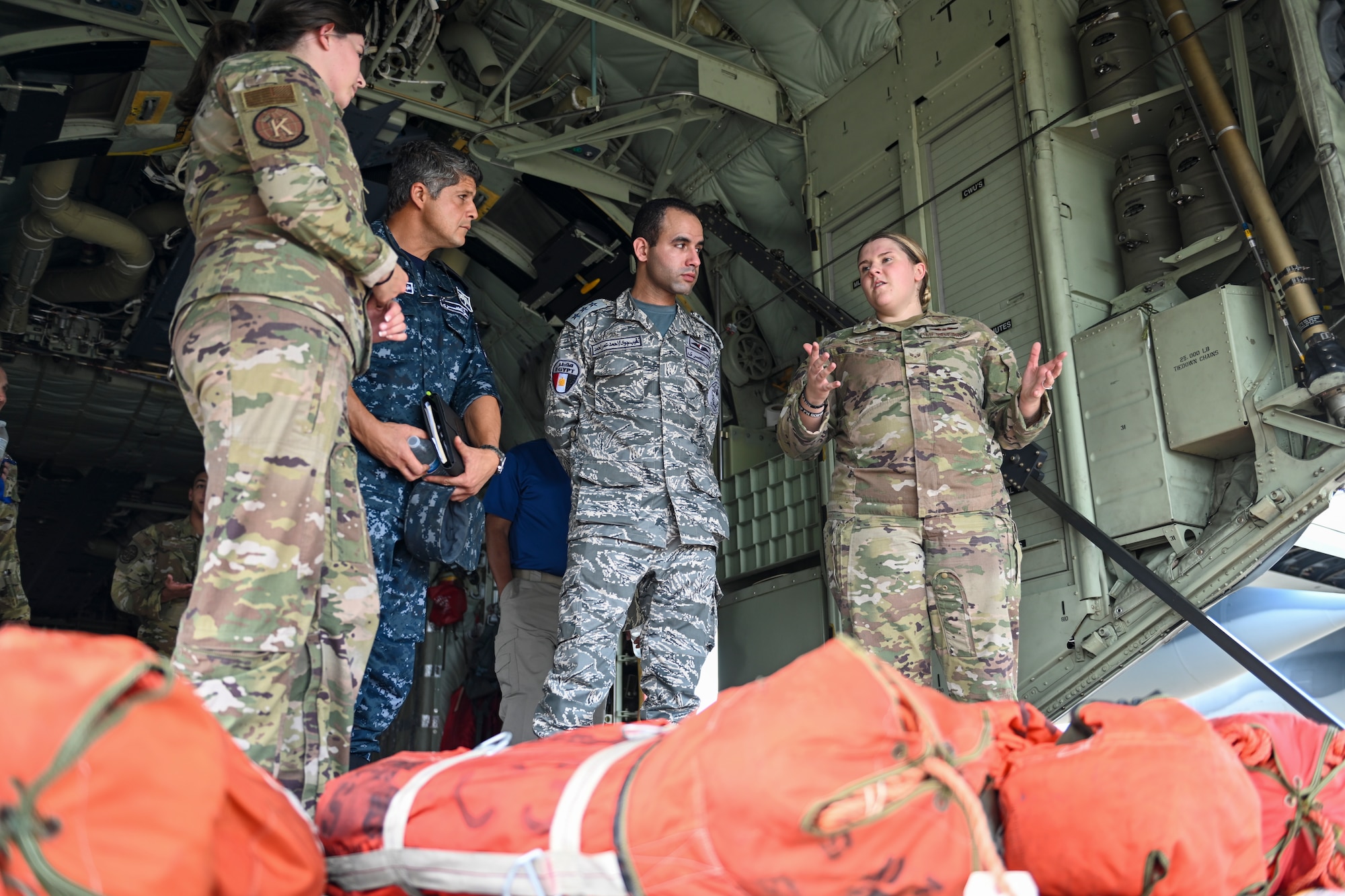 U.S. Air Force Senior Airman Sierra Orozco, left, and Senior Airman Taryn Kraemer, 71st Rescue Squadron loadmasters, showcase a C-130J Combat King II to members of Egypt’s Air Force and Navy during a CSAR subject matter expert exchange at Moody Air Force Base, Georgia, Sept. 13, 2022. Egypt and the United States share a strategic security relationship, which plays a leading role in regional security and efforts to combat the spread of extremism. Engagements such as this ensure that the security relationship is not only forged at the strategic level but also the tactical and operational levels, creating a cohesive, layered approach to creating a safe and stable theater. (U.S. Air Force photo by Airman 1st Class Rachel Coates)