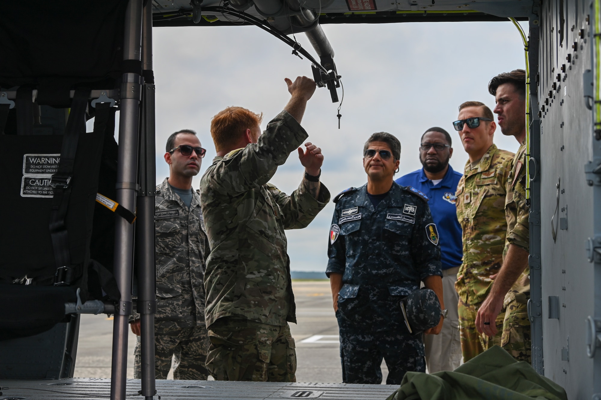 U.S. Air Force Capt. Garrett Treaster, 38th Rescue Squadron red-team flight commander, explains the pulley system on an HH-60W Jolly Green II to members of Egypt’s Air Force and Navy during a CSAR subject matter expert exchange at Moody Air Force Base, Georgia, Sept. 13, 2022. Egypt and the United States share a strategic security relationship, which plays a leading role in regional security and efforts to combat the spread of extremism. Engagements such as this ensure that the security relationship is not only forged at the strategic level but also the tactical and operational levels, creating a cohesive, layered approach to creating a safe and stable theater. (U.S. Air Force photo by Airman 1st Class Rachel Coates)