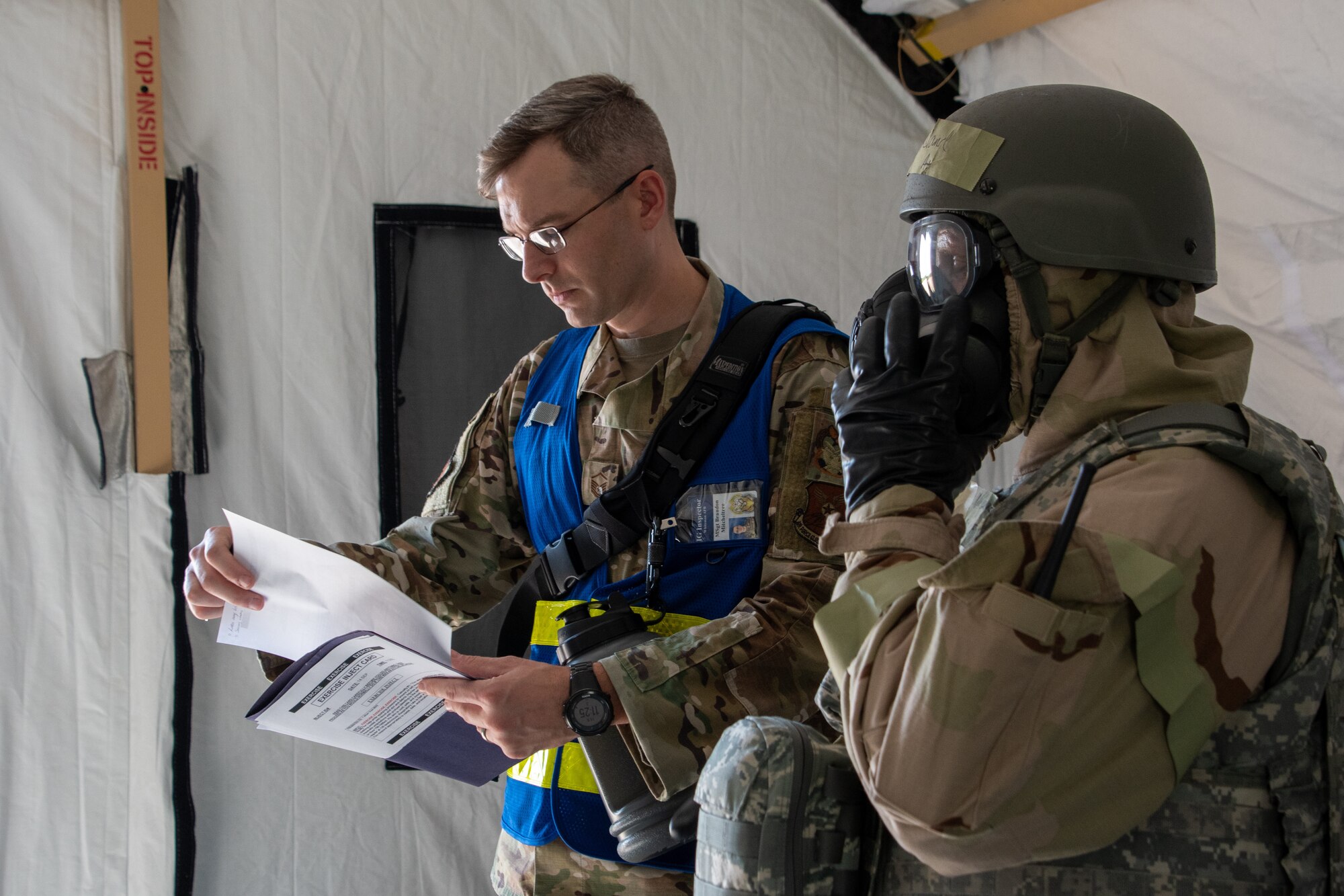 U.S. Air Force Master Sgt. Brandon Mitcheltree, Whiteman Air Force Base Wing Inspection Team member, evaluates Maj. John Copeland, 509th Bomb Wing flight medical member, during a Chemical, Biological, Radiological, Nuclear exercise at Whiteman Air Force Base, Missouri, Sept. 14, 2022. Whiteman’s WIT ensures Airmen are mission capable by finding deficiencies during an exercise and making any corrections needed for future readiness. (U.S. Air National Guard photo by Airman 1st Class Phoenix Lietch)