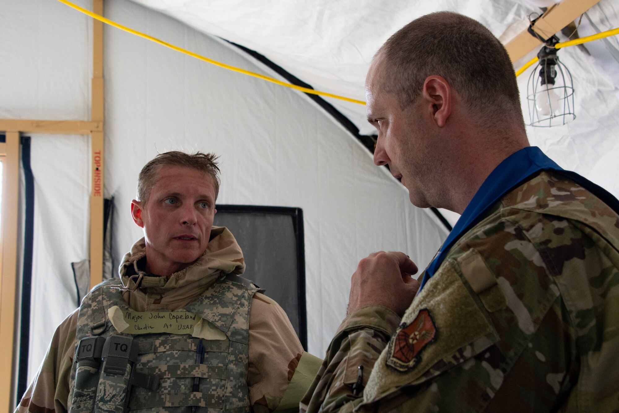 U.S Air Force Maj. John Copeland, 509th Bomb Wing flight medical member, is inspected by Maj. Micha Emerson, Whiteman Air Force Base Wing Inspection Team member, during a Chemical, Biological, Radiological, Nuclear exercise at Whiteman Air Force Base, Missouri, Sept. 14, 2022. Whiteman’s WIT are experts in their career fields and provide exercise participants with constructive feedback for Airmen to improve mission capabilities. (U.S. Air National Guard photo by Airman 1st Class Phoenix Lietch)