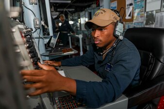 Operations Specialist 2nd Class Travelle Dejarnette tracks surface vessels aboard USS Higgins (DDG 76) during a replenishment-at-sea in the South China Sea.