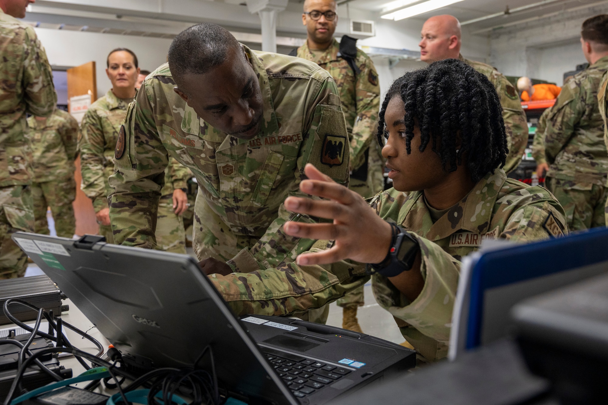 U.S. Air Force Chief Master Sgt. Maurice Williams, center, command chief, Air National Guard, speaks with an Airman assigned to the 239th Combat Communications Squadron, 131st Bomb Wing, Missouri National Guard, at Jefferson Barracks Air National Guard Base, St. Louis, Missouri, Sept. 11, 2022. During his visit, Williams spoke with leadership and Airmen about the importance of the mission, leadership qualities and the Airmen's impact on the future of the Air Force. (U.S. Air National Guard photo by Senior Airman Whitney Erhart)