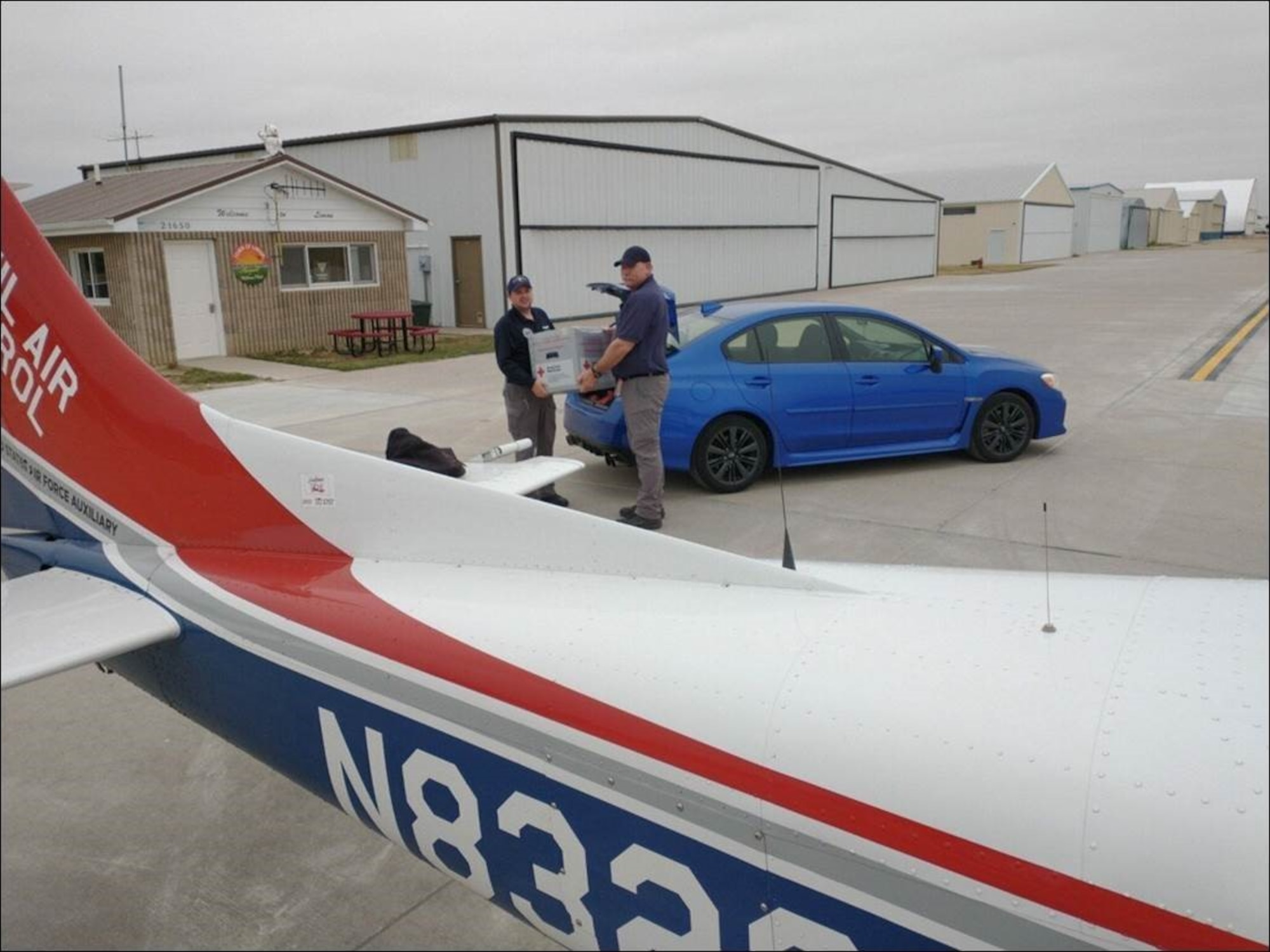 First Lieutenants Douglas Payne (left) of the Colorado Wing’s Black Sheep Senior Squadron and Doug Peters of the Kansas Wing’s Air Capital Composite Squadron carry out the blood product transfer at Limon Municipal Airport in Colorado. (Civil Air Patrol courtesy photo)