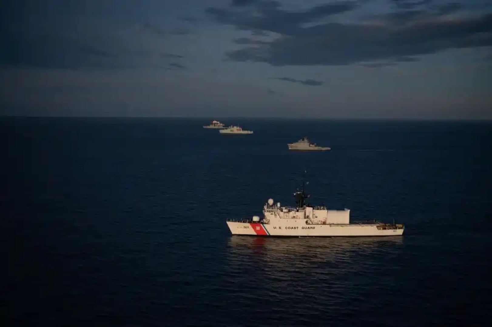 USCGC Bear (WMEC 901) is seen from the left side of a formation during a photo exercise (PHOTOEX) as a part of Operation Nanook, Northern Atlantic Ocean, Aug. 6, 2022. Bear is partaking in the Tuugaalik phase of Operation Nanook, an annual exercise that allows the United States and multiple other partner nations to ensure security and enhance interoperability in Arctic waters. (U.S. Coast Guard photo by Petty Officer 3rd Class Matthew Abban)