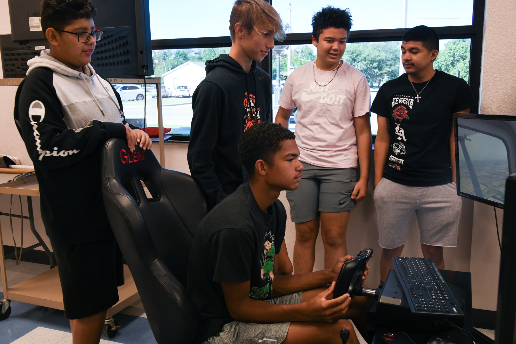 A high school student demonstrates flying an aircraft using an X-Plane 11 simulator at Altus High School, Altus, Oklahoma, Sept. 21, 2022. The simulators were funded by the Air Force Science, Technology, Engineering and Math program through the 97th Air Mobility Wing. (U.S. Air Force photo by Airman 1st class Miyah Gray)