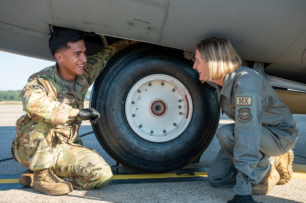 Airmen change a tire on an aircraft.