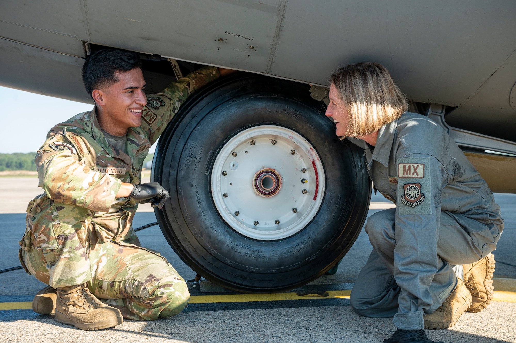 Airmen change a tire on an aircraft.