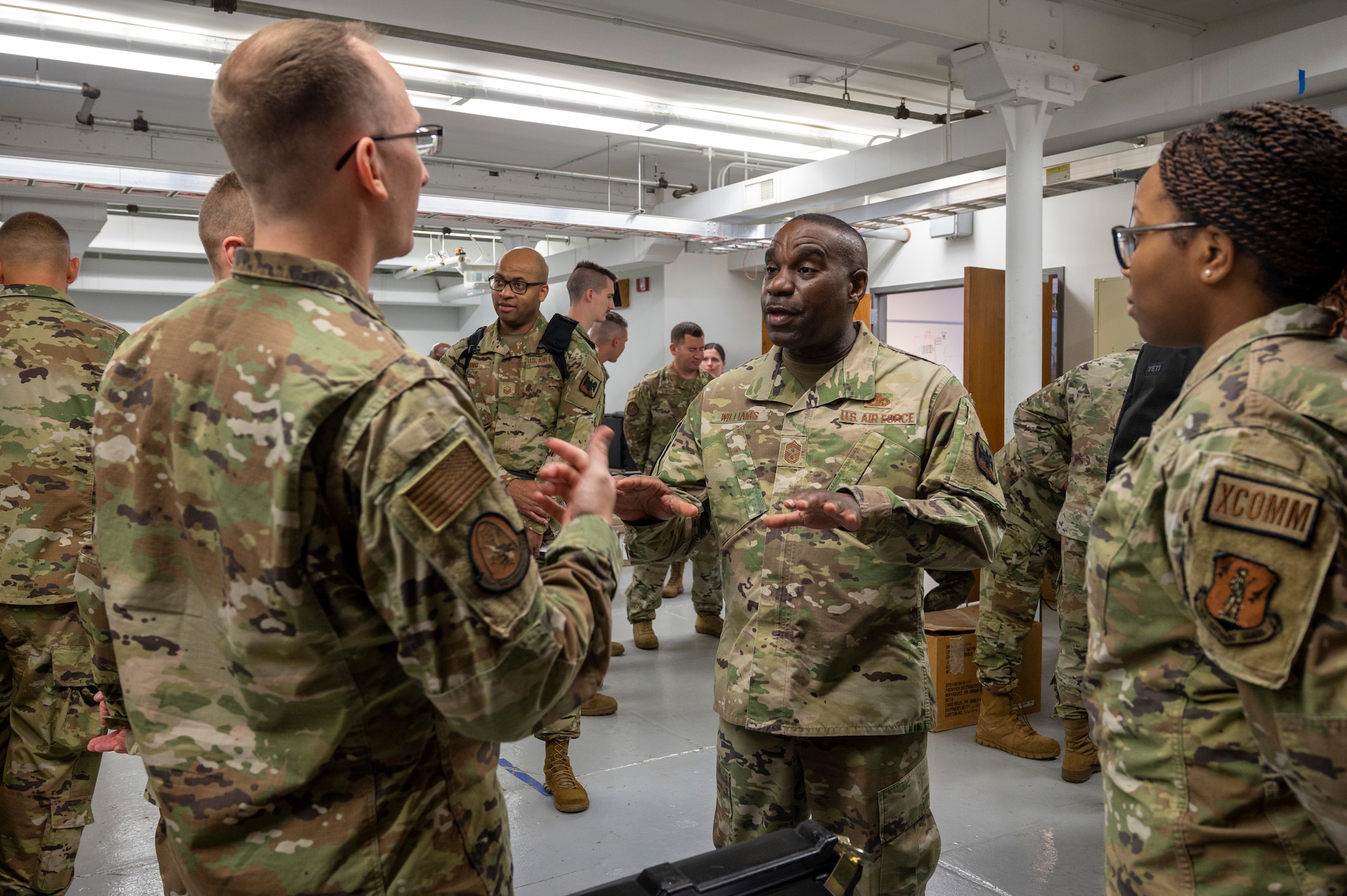 U.S. Air Force Chief Master Sgt. Maurice Williams, center, command chief, Air National Guard speaks with Airmen assigned to the 239th Combat Communications Squadron, 131st Bomb Wing, Missouri National Guard at Jefferson Barracks Air National Guard Base, St. Louis, Missouri, Sept. 11, 2022. During his visit, Williams spoke with leadership and Airmen about the importance of the mission, leadership qualities and the Airmen's impact on the future of the Air Force. (U.S. Air National Guard photo by Senior Airman Whitney Erhart)