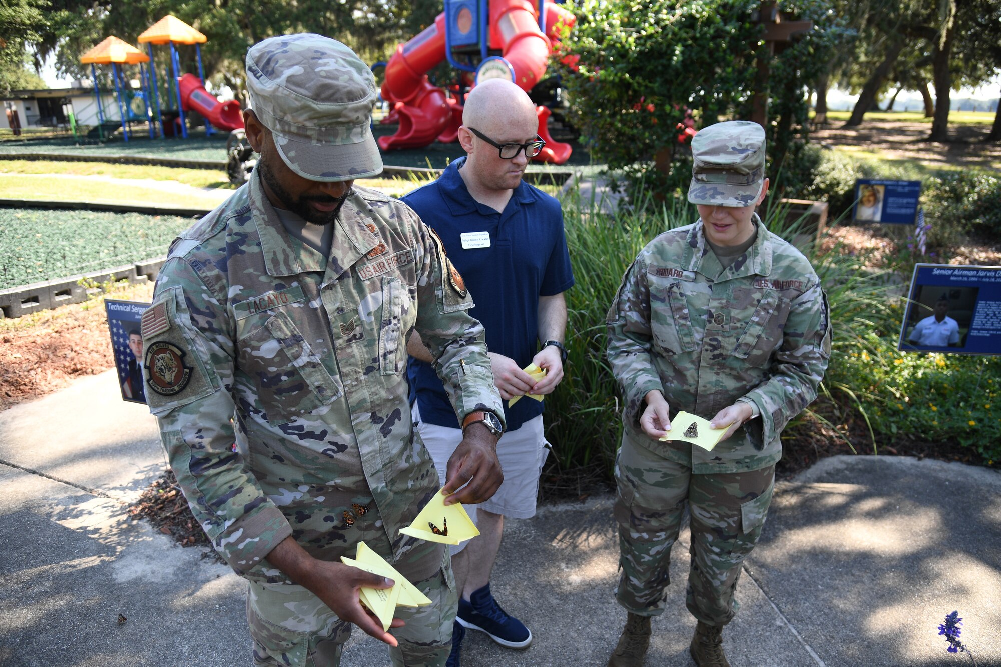 U.S. Air Force Tech. Sgt. Louis Lacayo, 336th Training Squadron instructor, Master Sgt. Jimmy Atwater, 81st Force Support Squadron first sergeant, and Master Sgt. Stephanie Todaro, 81st Comptroller Squadron first sergeant, release butterflies during the Air Force Families Forever Fallen Hero Butterfly Release at the marina park at Keesler Air Force Base, Mississippi, Sept. 23, 2022. The garden serves as a designated location where the families of our fallen heroes can find a serene area to pay tribute to their loved one as well as honoring our fallen service members. (U.S. Air Force photo by Kemberly Groue)