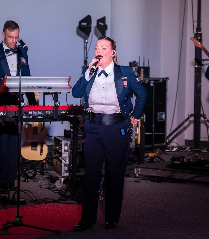 U.S. Air Force Senior Airman Julia Keough-Mishler lead singer of the Heritage of America Band’s Full Spectrum Ensemble, performs during the Air Force Ball at Virginia Air and Space Center, Hampton, Virginia, Sept. 17, 2022.