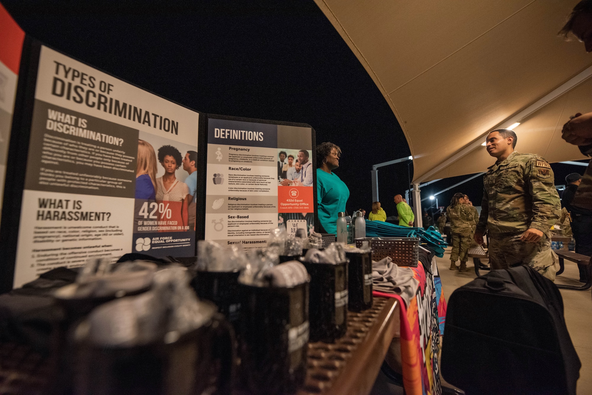 Melody Monroe speaks about the SAPR office to Airmen during the late night barbecue.