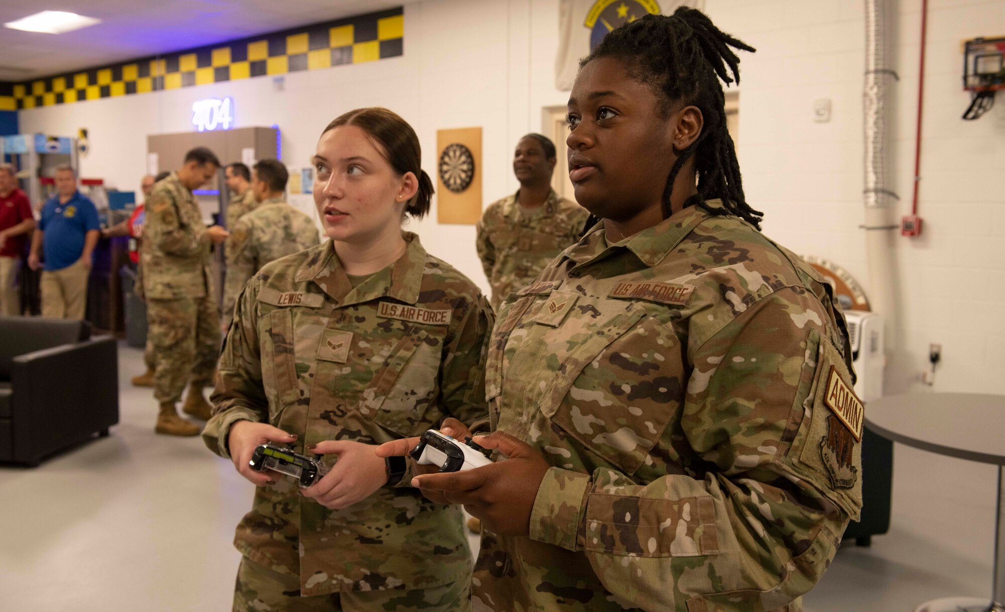 Two uniformed members play videos games.